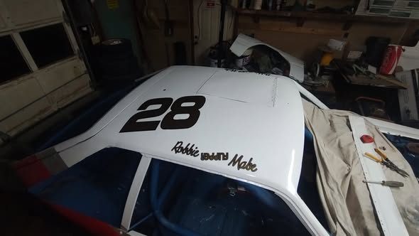 The number 28 on the roof of the race car in the shop